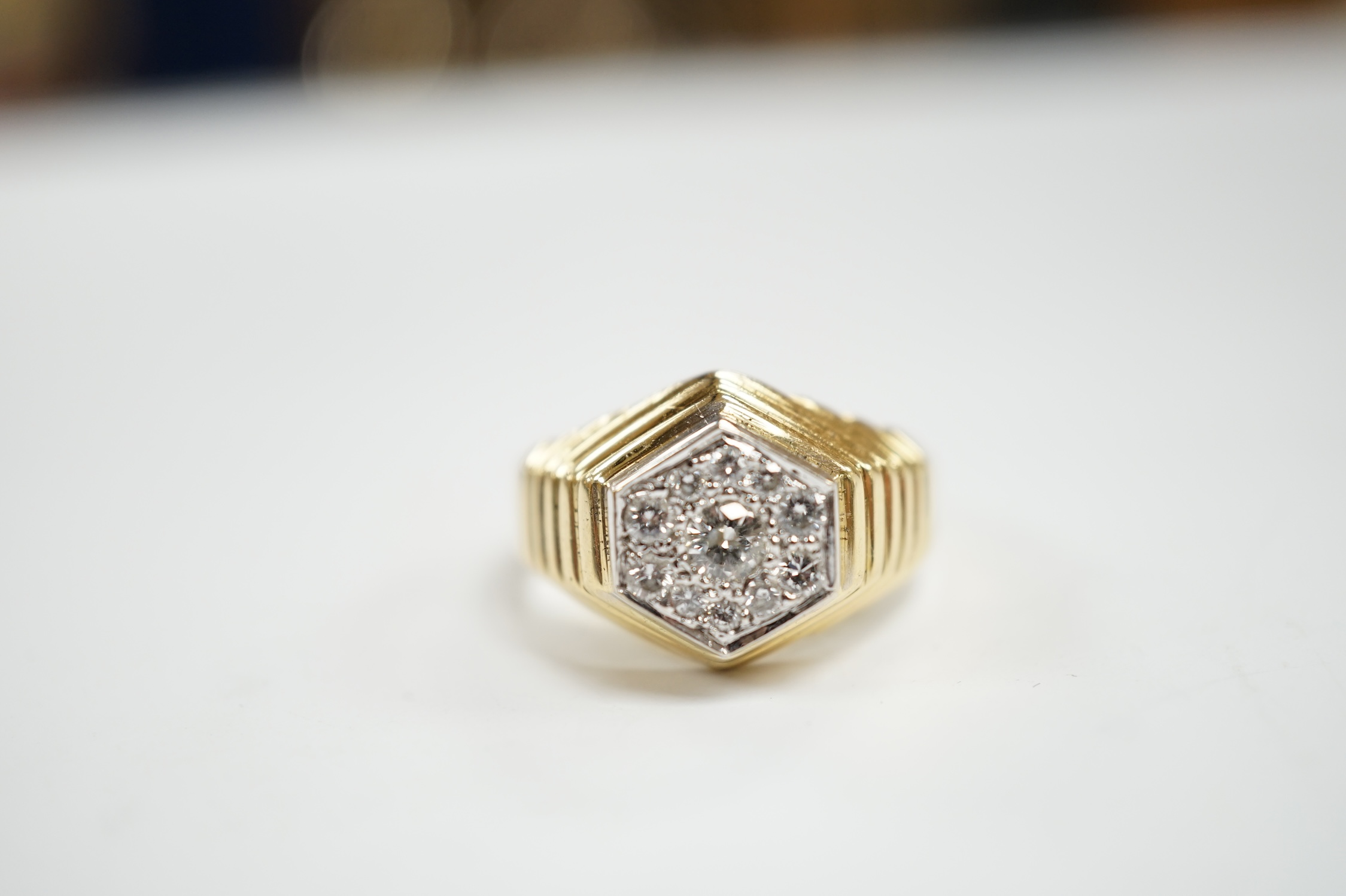 A modern 18ct gold and diamond set hexagonal cluster ring, size Q, gross weight 11.3 grams.